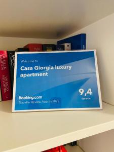 a sign on top of a shelf with books at Casa Giorgia luxury apartment in Rome