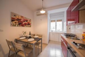 a kitchen with a table and chairs and a sink at Central View Zadar in Zadar +16 photos