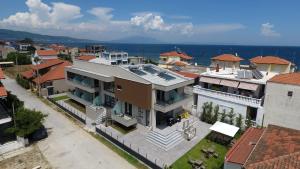 an aerial view of a large house with the ocean at Cynthia in Nea Vrasna