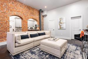 a living room with a couch and a brick wall at The Jazz in New Orleans