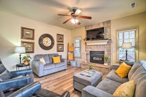 a living room with couches and a fireplace at Branson West Villa w/ Golf Course View & Pool! in Branson West