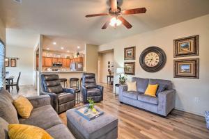 a living room with couches and a ceiling fan at Branson West Villa w/ Golf Course View & Pool! in Branson West