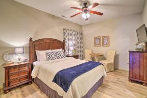 a bedroom with a bed and a ceiling fan at Branson West Villa w/ Golf Course View & Pool! in Branson West +31 photos