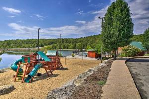 a playground with a slide next to the water at Branson West Villa w/ Golf Course View & Pool! in Branson West