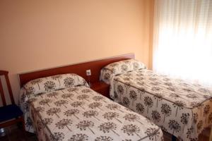 CASA RURAL HOCES DEL MESA في خارابا: غرفة نوم بسريرين ونافذة