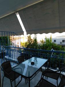 a table and chairs on top of a patio at Anna house 1 in Sarti +6 photos