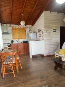 a kitchen and dining room with a table and chairs at Cabaña I Punta Negra in Piriápolis