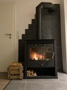 a fireplace with a fire in it in a room at Ferienhaus Quell in Sankt Martin