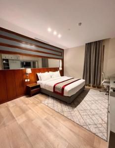 - une chambre avec un lit et un bureau dans l'établissement Biz Hotel Apartments, à Tabuk