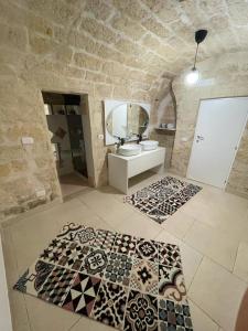 a bathroom with a sink and a mirror at L’INFANZIA HOLIDAY HOME in Bari