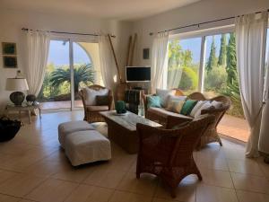 a living room with a couch and chairs and a tv at Carpe Diem in Zipárion