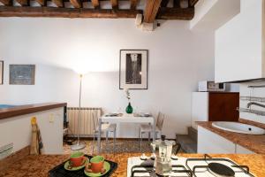 a kitchen with a table with cups on a counter at Cà Paola Cozy Venice Apartment in Venice