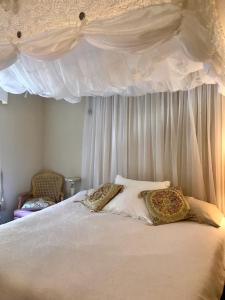 a white bed with two pillows on top of it at Woodstock Inn Bed & Breakfast in Independence