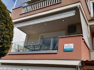 a large window in a house with a sign on it at Bella Casa in Nea Peramos