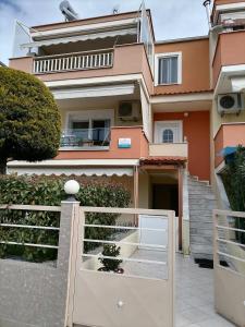 a house with a gate in front of it at Bella Casa in Nea Peramos