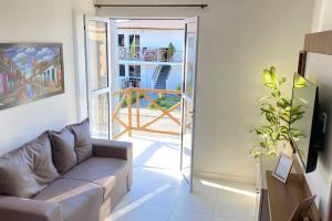 a living room with a couch and a balcony at Brisas do Lago I in Paulo Afonso