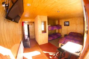 an overhead view of a room with a bedroom and a tv at Hostal El Pichon in Farellones