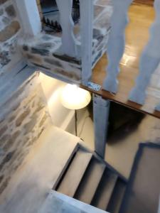 a lamp sitting next to a staircase in a room at La Casa del Sol in Keramídhion