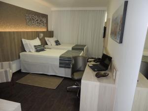 Cama ou camas em um quarto em Allia Gran Pampulha Suites