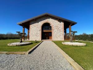 a building with two trees in front of it at Agriturismo Albana in Castiglione delle Stiviere