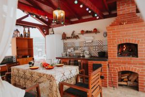 a kitchen with a table and a brick fireplace at Lorem in Daugavpils