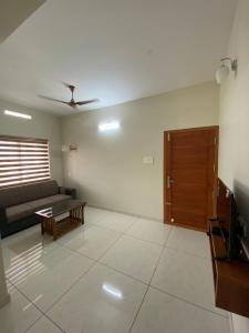 a living room with a couch and a table at Nimet Residency in Ernakulam