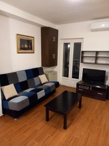 a living room with a couch and a coffee table at Apartments Teodora Obala in Petrovac na Moru