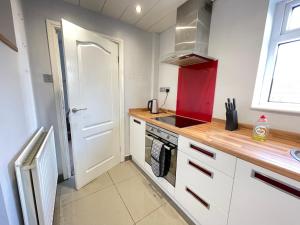 a kitchen with a stove top oven next to a window at Durham Eastside Professional Let - Durham city in Ushaw Moor