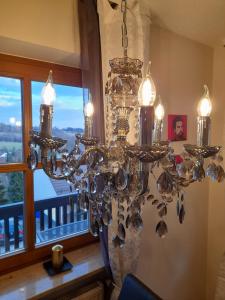 a chandelier hanging in a room with a window at Ferienwohnung Lucky Luggi in Bad Griesbach in Bad Griesbach