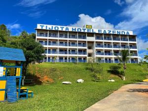 a hotel building with a playground in front of it at Tijota Hotel Fazenda in Ipatinga