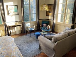a living room with a couch and a table at Domaine de la Cressonnière 