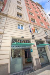 a building with a sign in front of it at Casual Colours Barcelona in Barcelona