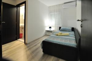 a bedroom with a bed and a door to a bathroom at Villa Paradiso By Italy in Mostar