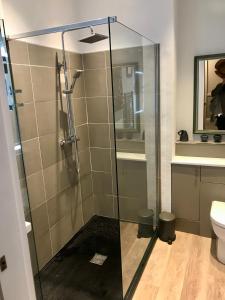 a bathroom with a glass shower with a toilet at Crescent Bank in Buxton +21 photos