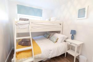 a bedroom with two bunk beds and a desk at Dartside 55 in Dartmouth