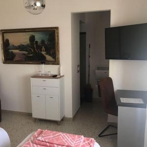 a room with a painting on the wall and a desk at Casa Giulia in Porto SantʼElpidio