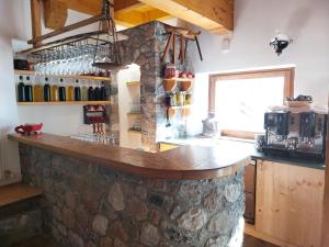 a kitchen with a stone counter in a room at Rifugio Fornas in Tolmezzo