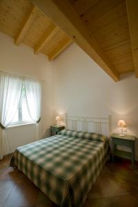 a bedroom with a bed and two tables with lamps at Casale di Pegol in Tignale