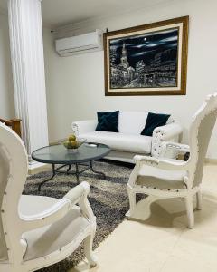 a living room with a couch and a table and chairs at Casa Dimares in Cartagena de Indias