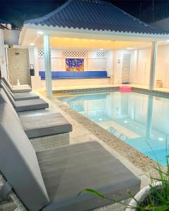 uma piscina com cadeiras em Casa Dimares em Cartagena das Índias