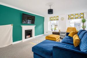 a living room with a blue couch and a fireplace at BRAND NEW LSITING!Wonderful One Bedroom Apartment in Bath