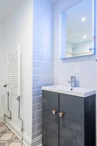 a white bathroom with a sink and a shower at BRAND NEW LSITING!Wonderful One Bedroom Apartment in Bath