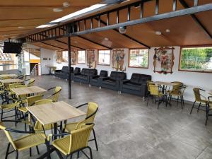 a restaurant with tables and chairs and a couch at Wake Up Cusco in Cusco