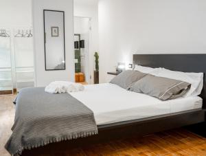a bedroom with a large bed with two towels on it at Civico64 apartments in Castellammare del Golfo
