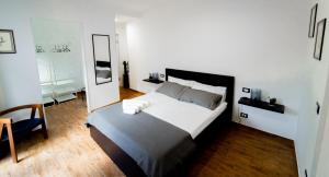 a bedroom with a large bed and a mirror at Civico64 apartments in Castellammare del Golfo