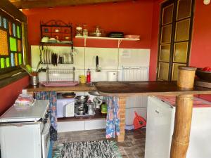 a small kitchen with a counter and some appliances at Casa Tambor Paraty in Paraty