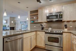 a kitchen with wooden cabinets and stainless steel appliances at Paradise Meadow in Breckenridge