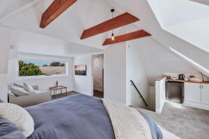 a bedroom with a bed and a living room at Marleys Loft in Mudgee