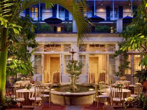 a large building with tables and chairs in front of it at The Royal Sonesta New Orleans in New Orleans