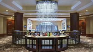 a table in a lobby with a chandelier at The Yorkville Royal Sonesta Hotel Toronto in Toronto